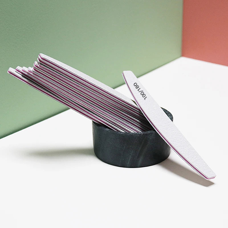 Set of nail files in a black holder against a colorful background. Nalaa Beauty